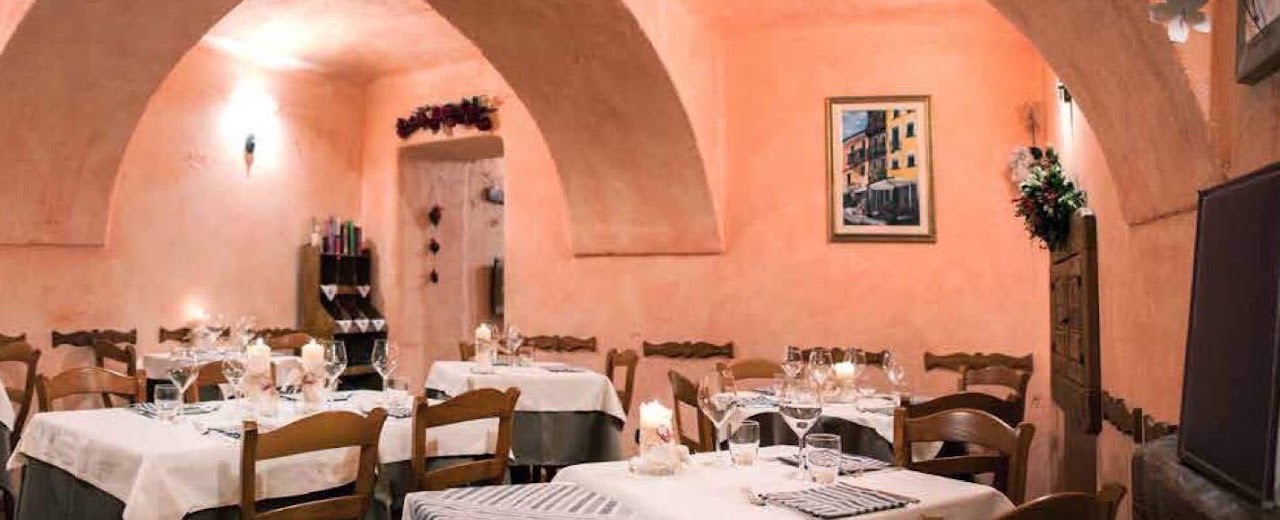 Interno dell'Osteria da Nando, sala raccolta nei toni rosati e bruni